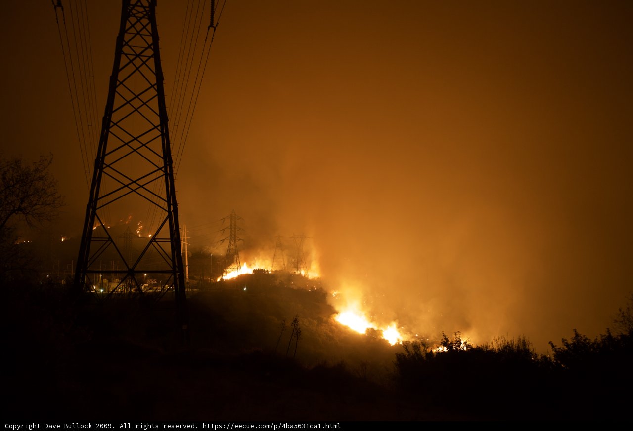 Flames Threaten Power Lines on Hillside