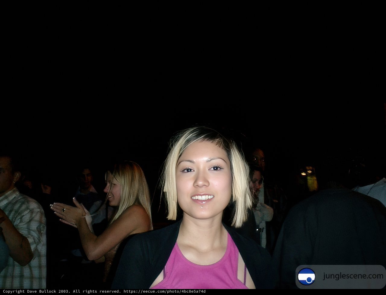 Pink-Shirted Woman in Front of a Crowd