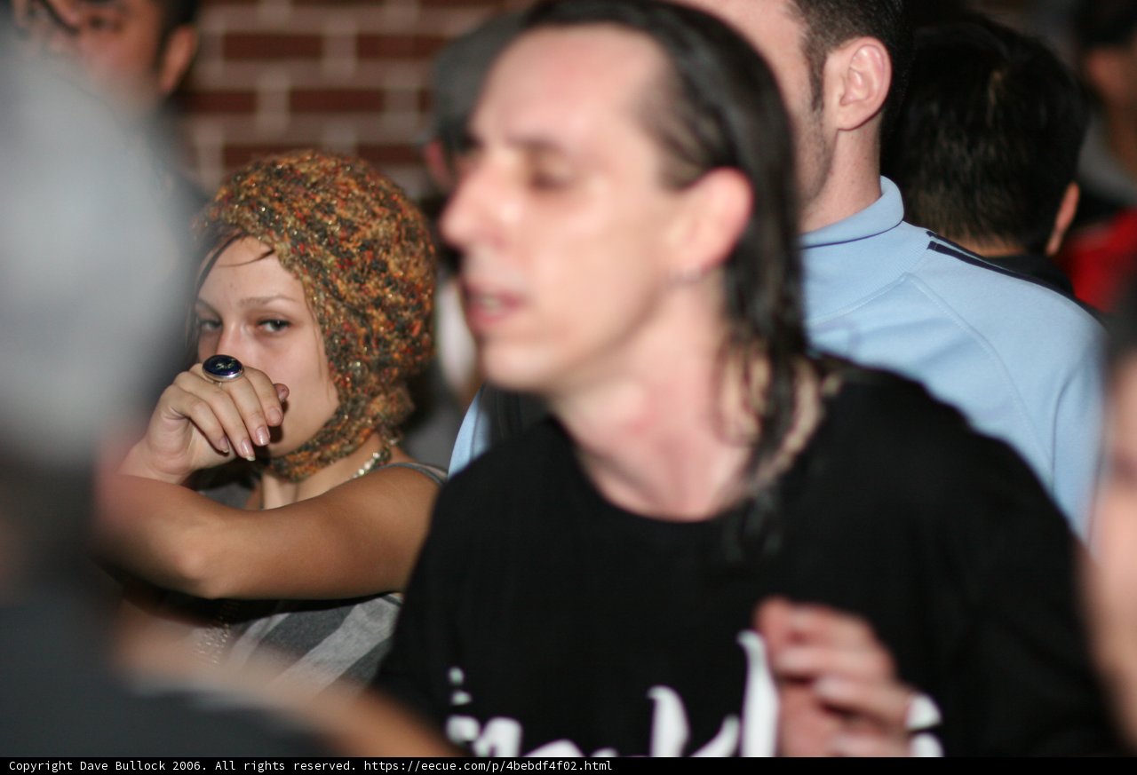 Hat-Wearing Trio at the Club