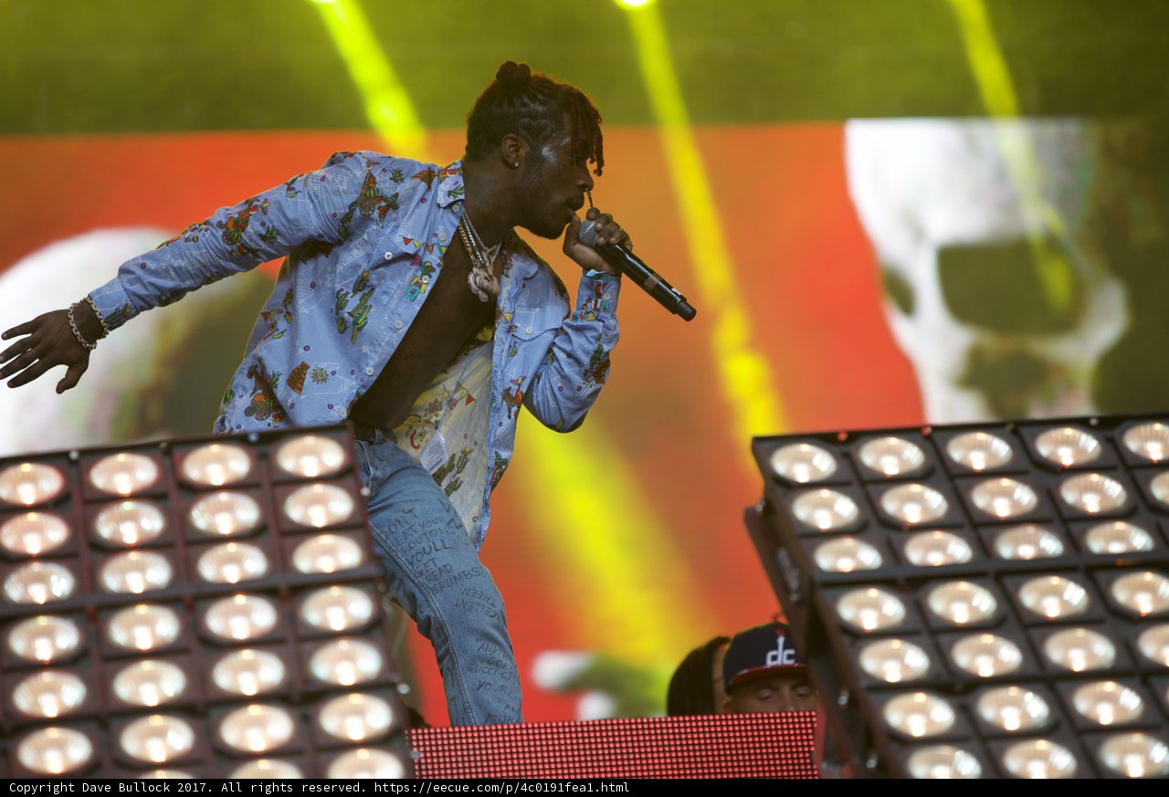 Blue-Shirted Man Belts Out Tunes to Packed Crowd