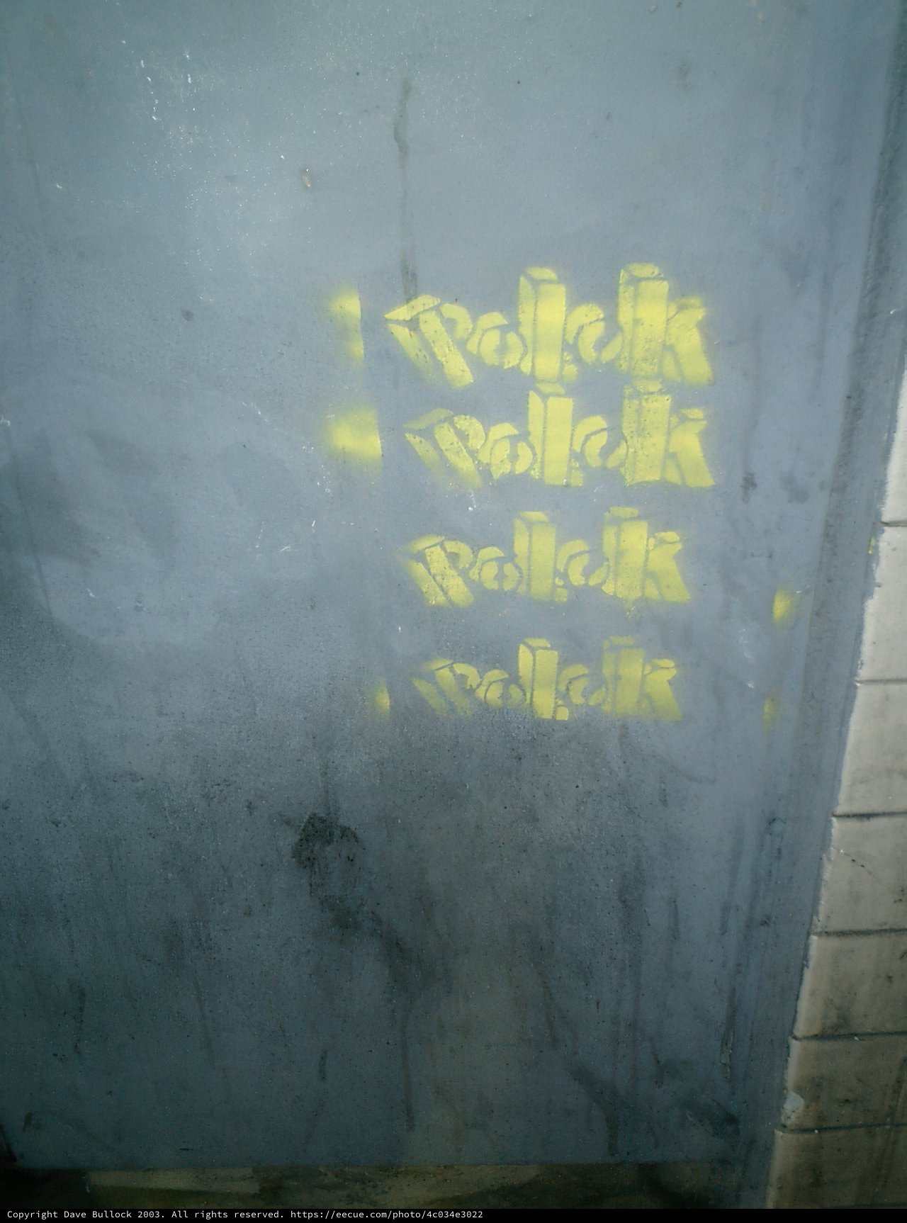 Bold Yellow Graffiti on Building Wall