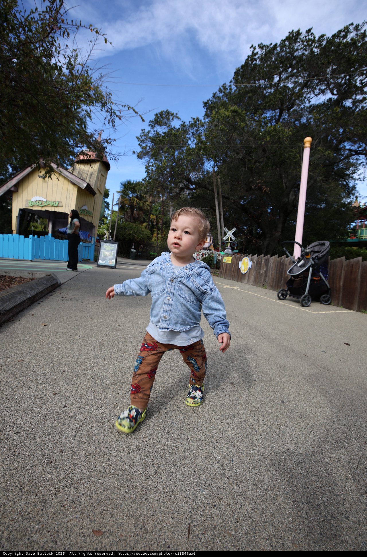 Toddler Exploring Theme Park Path in Denim