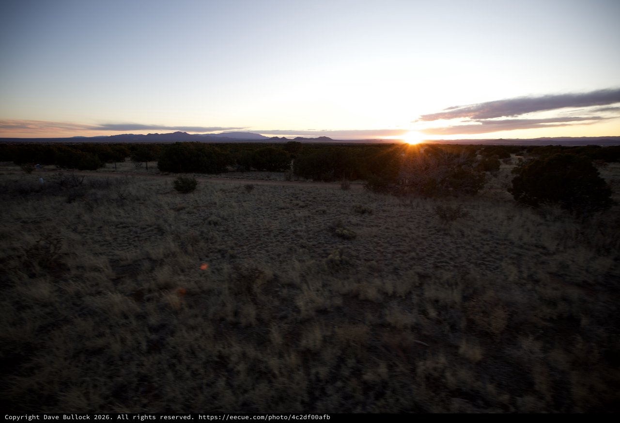 Desert Sunrise Over Distant Mountain Range