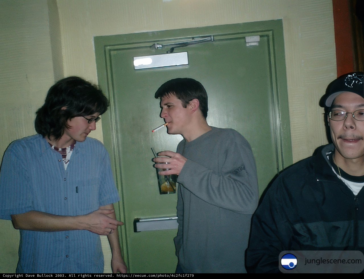 Three Young Men Posing in Front of a Door