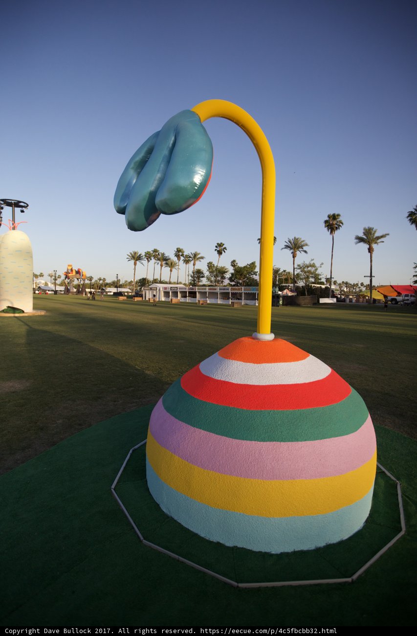 Vibrant Flower Sculpture on Grassy Field