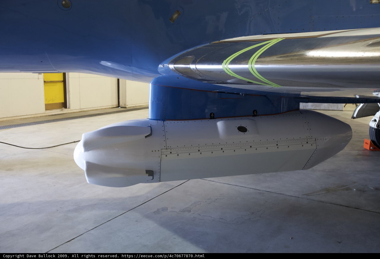 Blue and White Airplane Tail in Hangar