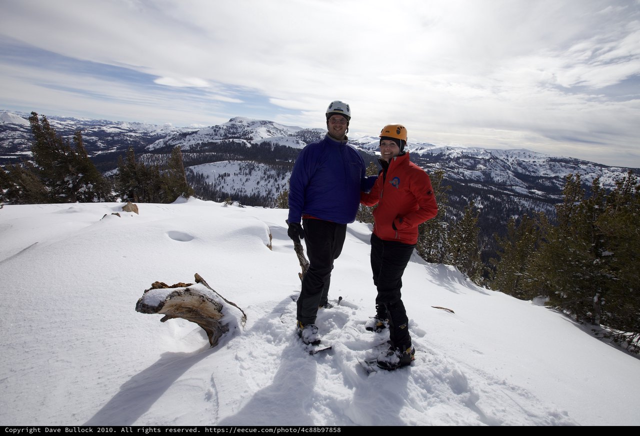 Summit Victory: Couple Atop Snow-Covered Sierra Peak