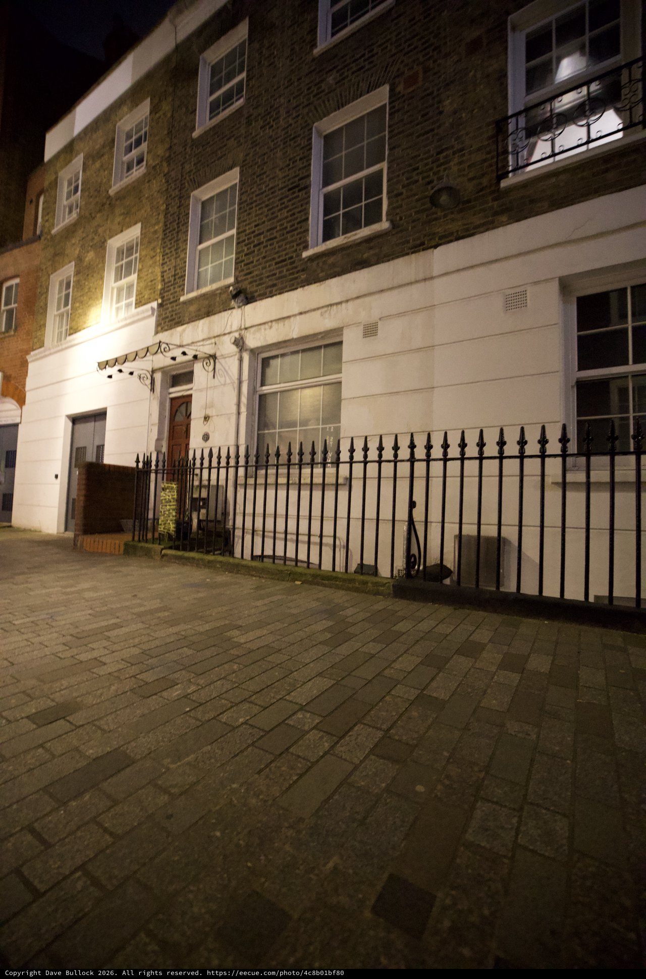 Victorian Townhouse at Night with Iron Railings