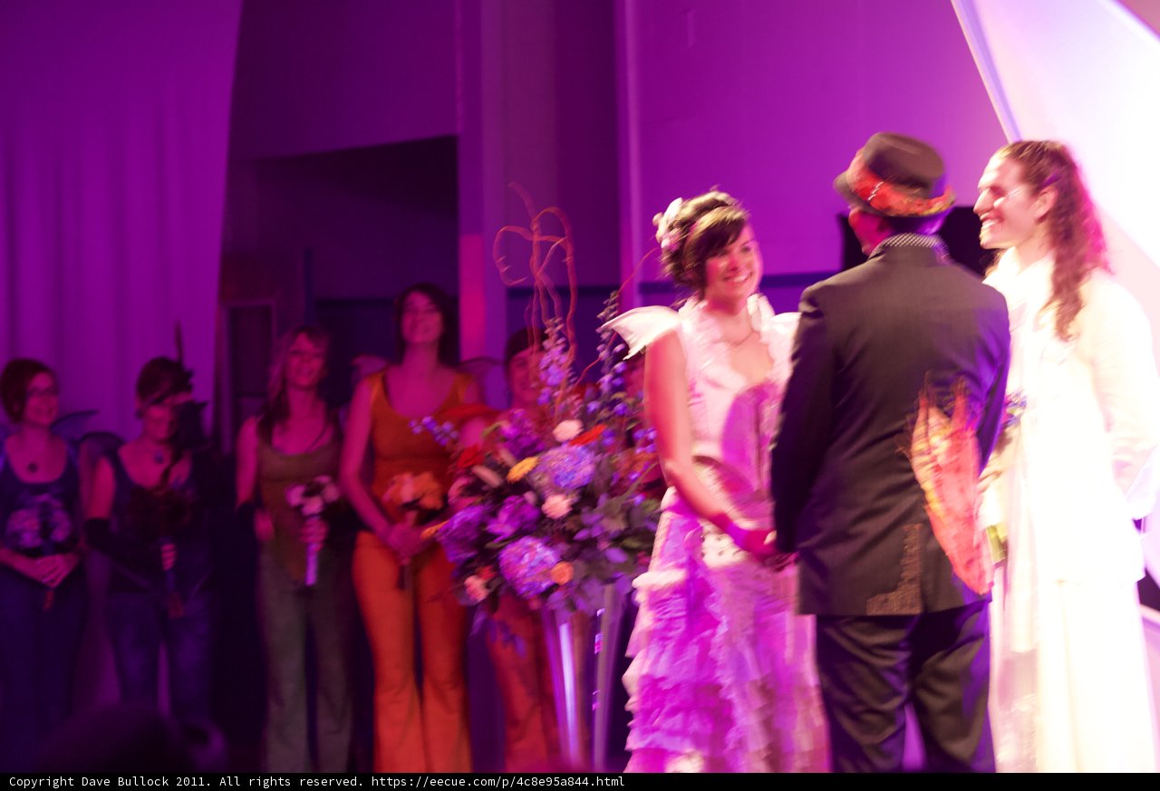 Wedding party poses with stunning flower arrangements