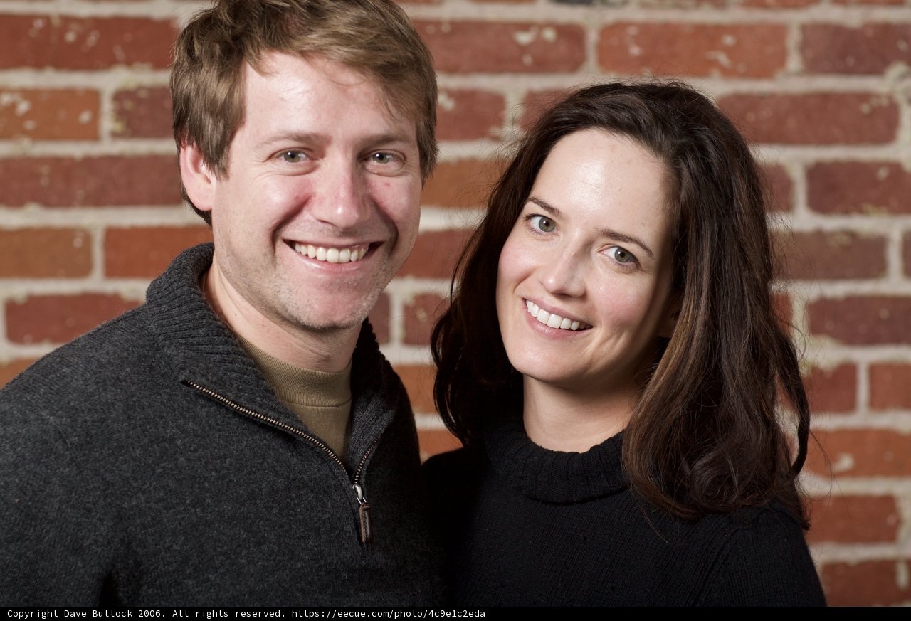 Smiling Couple in Front of Brick Wall