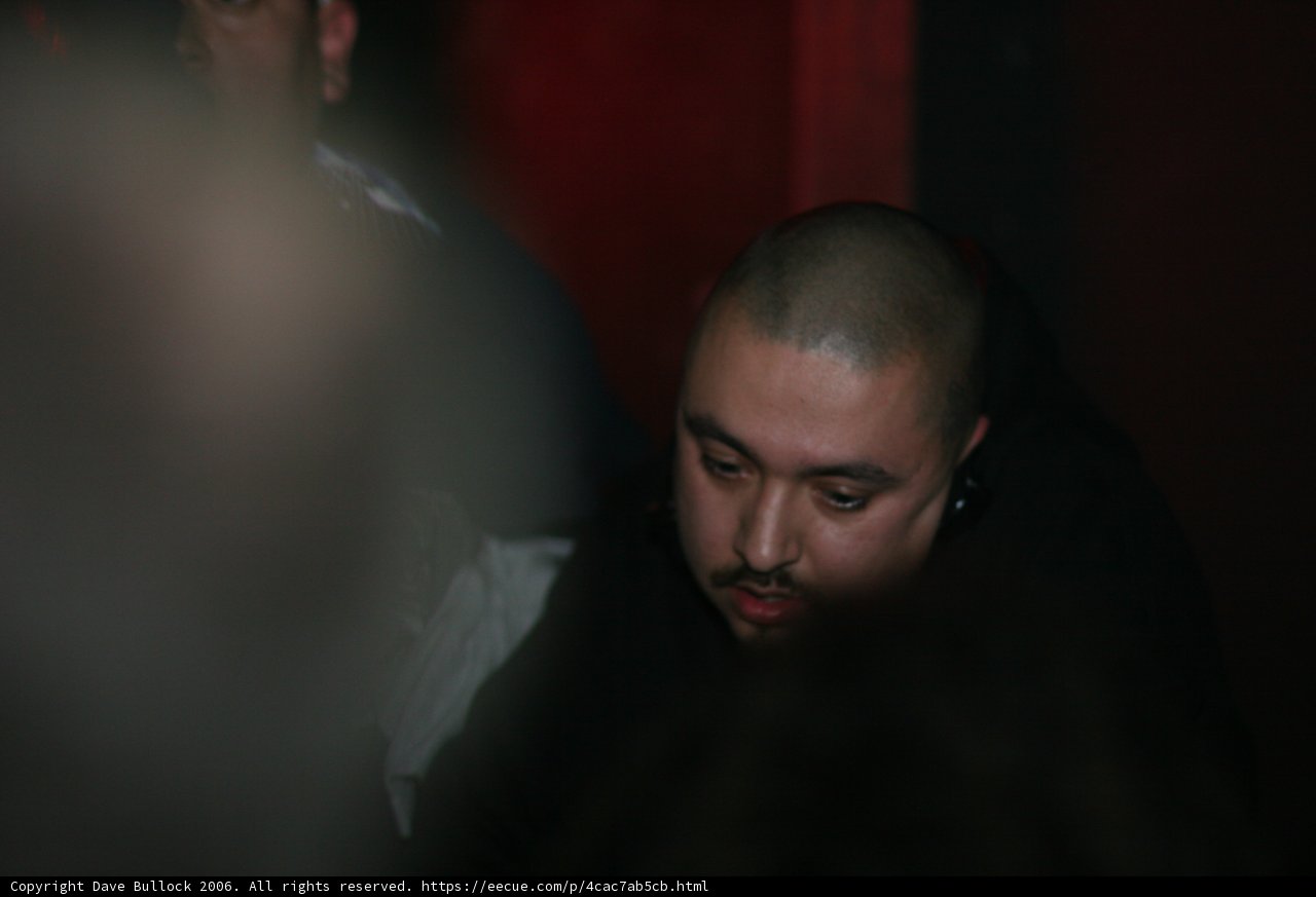 Shaved-Headed Man Sitting at a Table