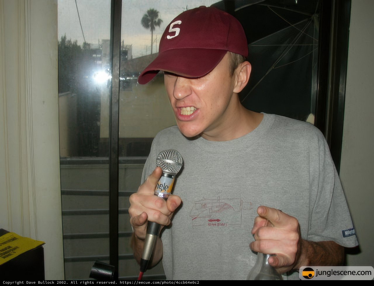 Man with Microphone and Baseball Cap