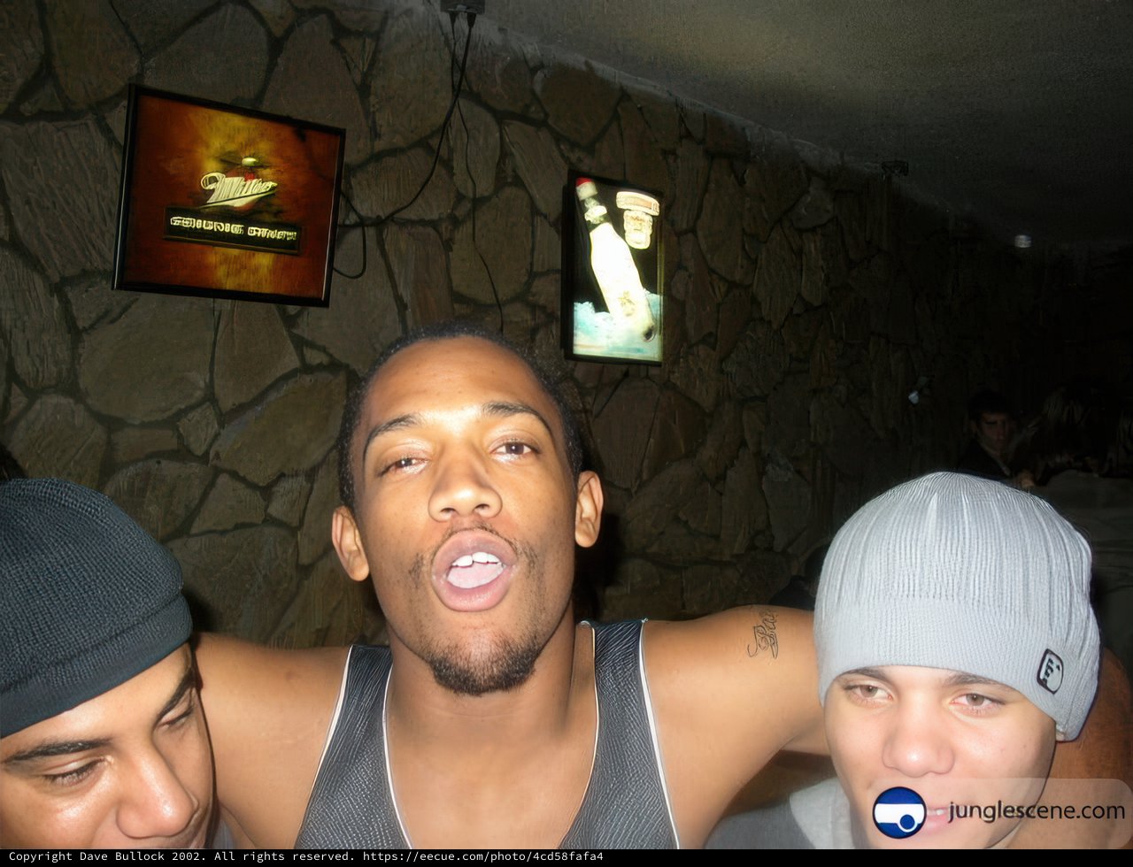 Three Men Strike a Pose in Front of the Television