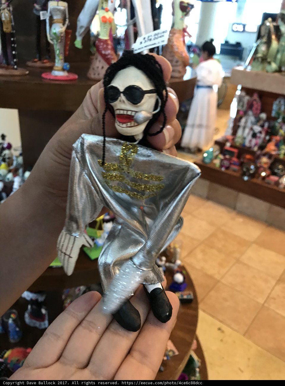 Silver Skeleton Figurine Held by a Woman