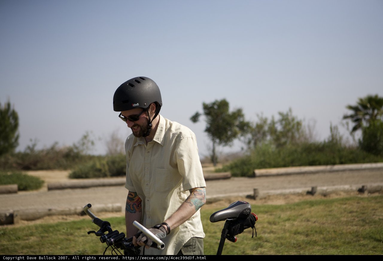 Man on a Bicycle Wearing a Protective Helmet