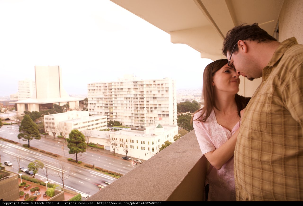 Couple Sharing an Intimate Moment on City Balcony