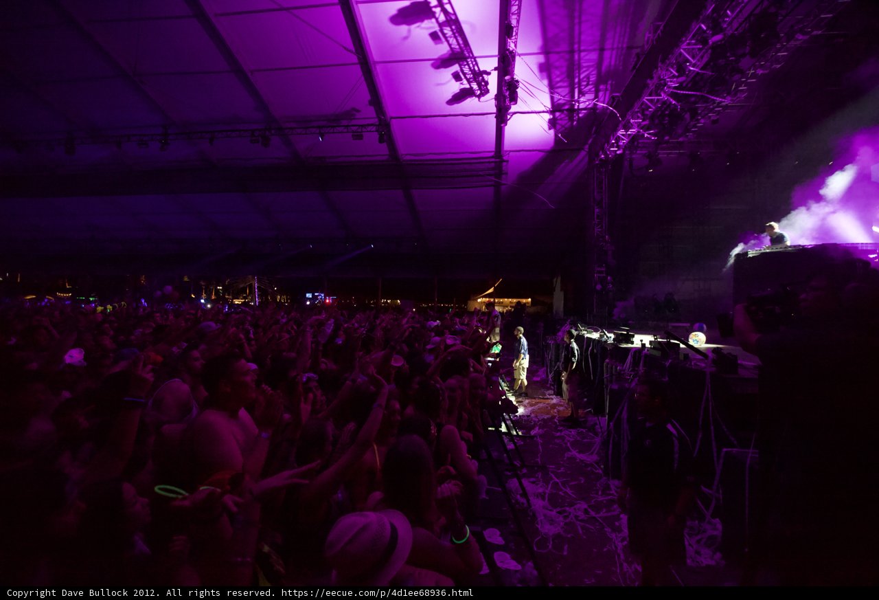 Purple Spotlight on Concert Crowd