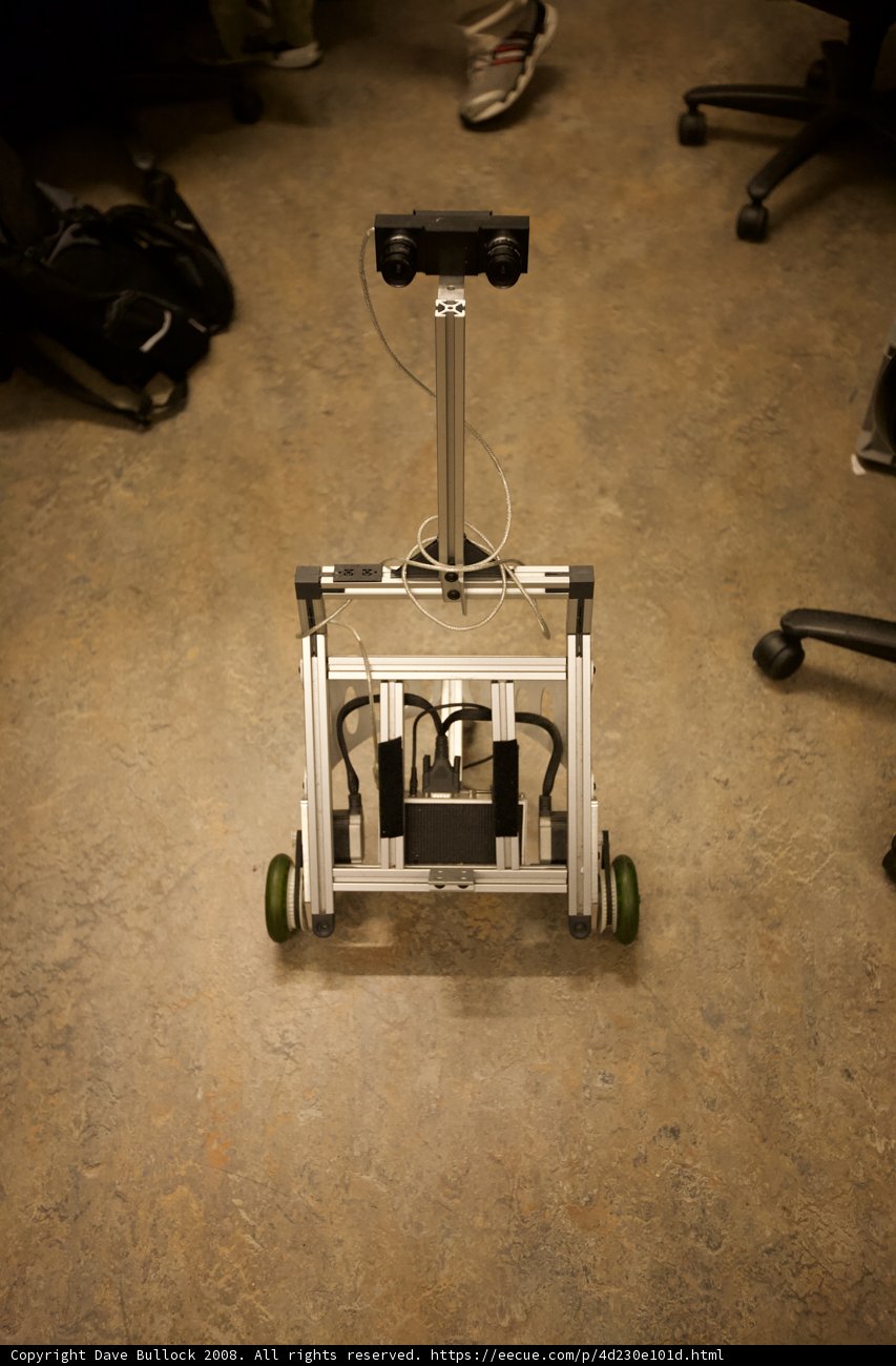 Robot and Computer on Wooden Floor