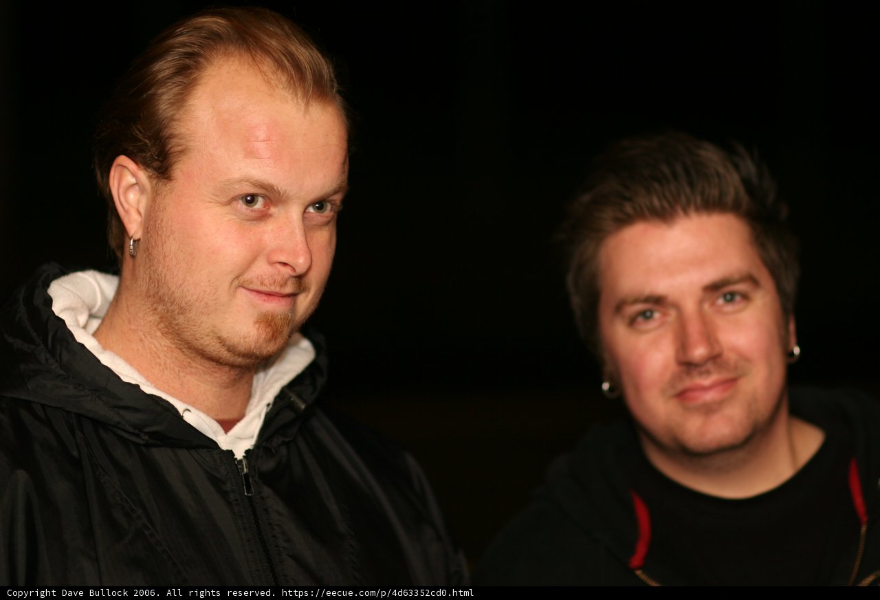 Two Men Standing Together in the Night