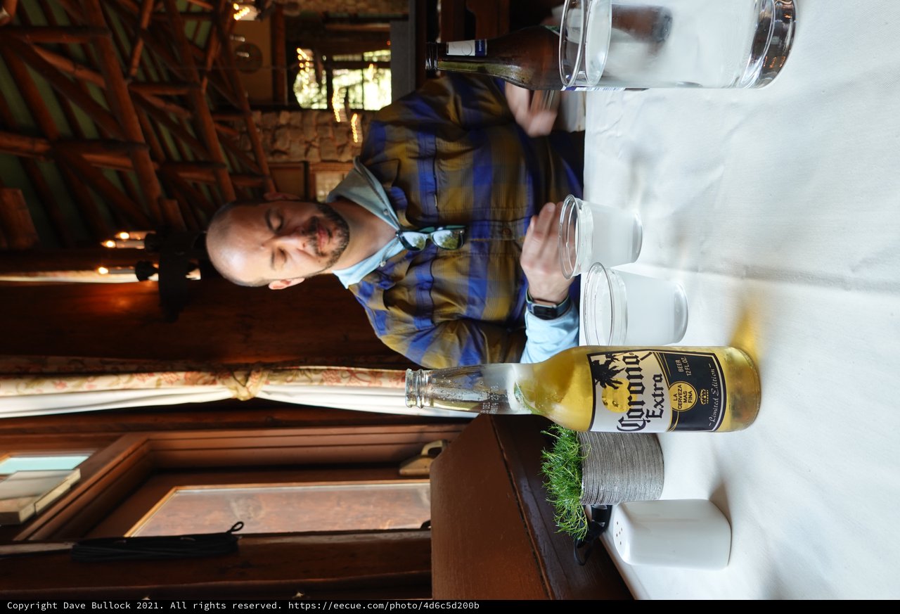 Man Enjoying Corona Beer at Rustic Restaurant