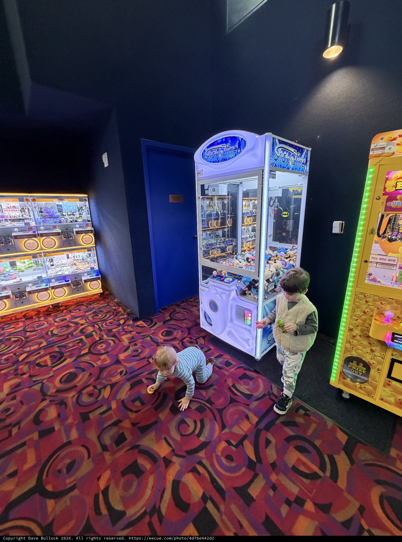 Children Playing at Arcade Claw Machine Area