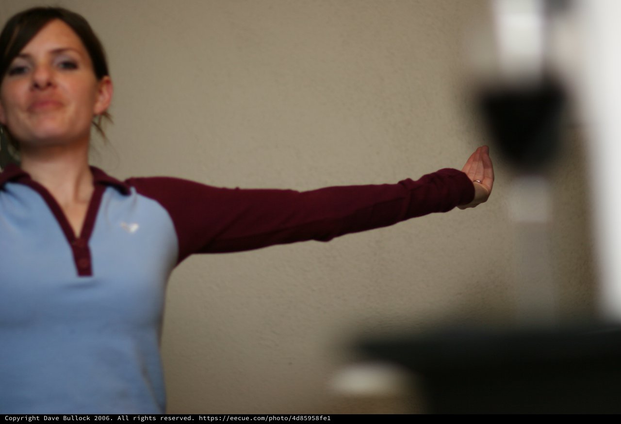 Woman Extends Arm in Focused Physical Therapy Pose