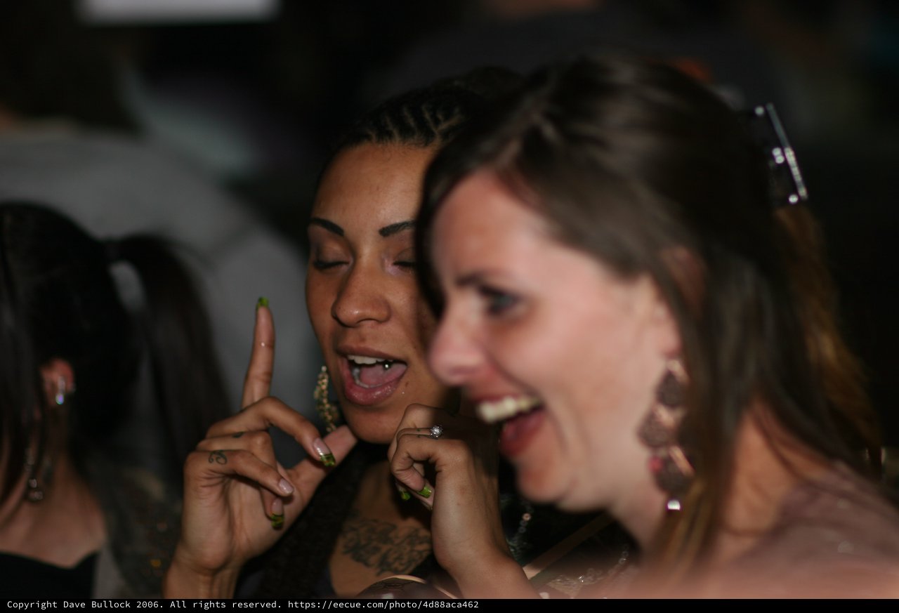 Two Women Laughing Together at Nightclub Event