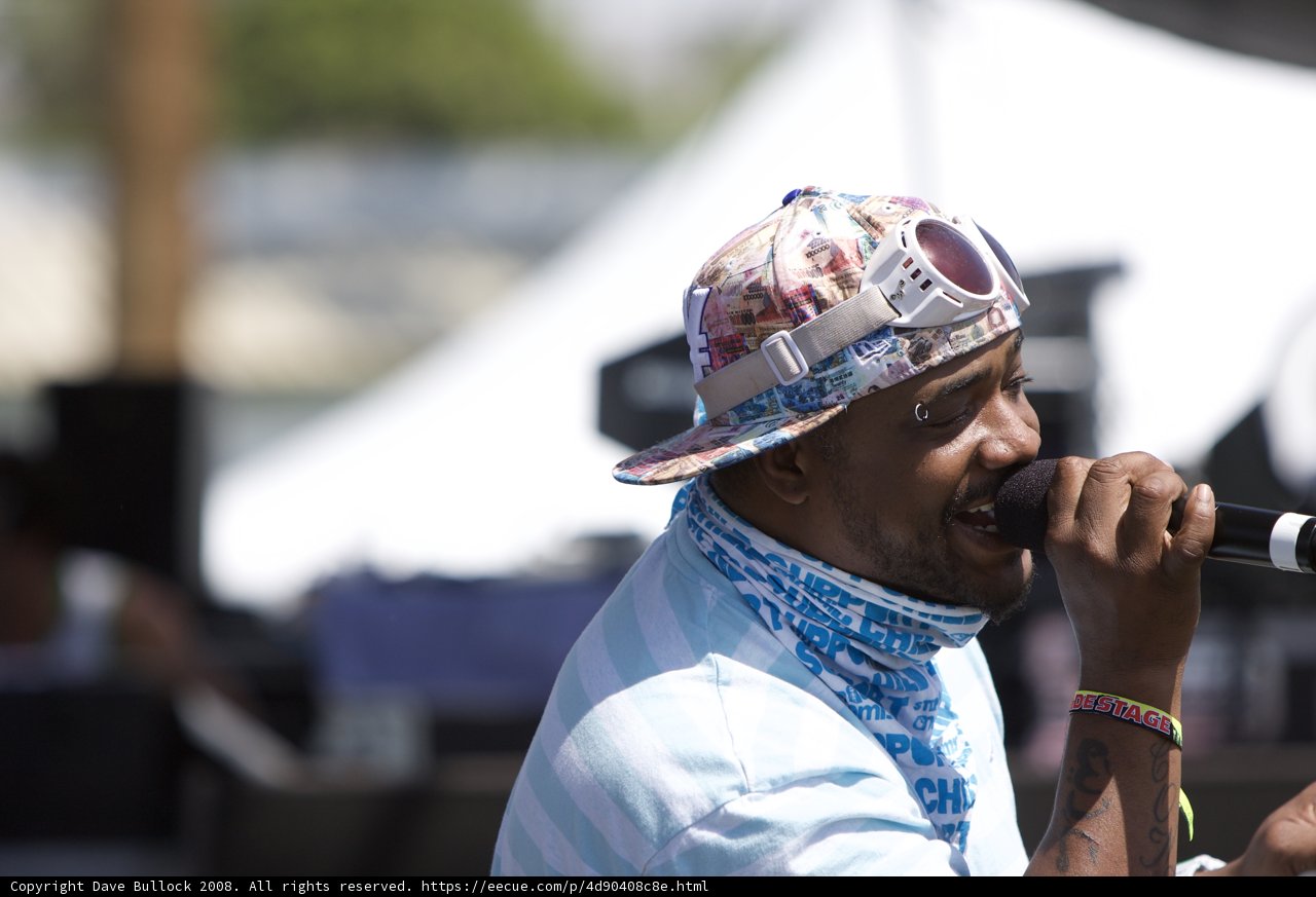 Man with Hat and Microphone Captivating the Stage