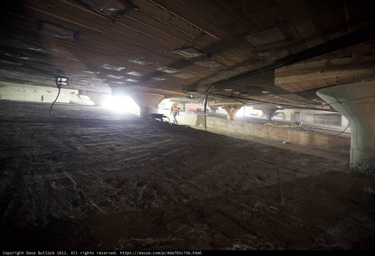 Lone Figure in Dilapidated Underground Room