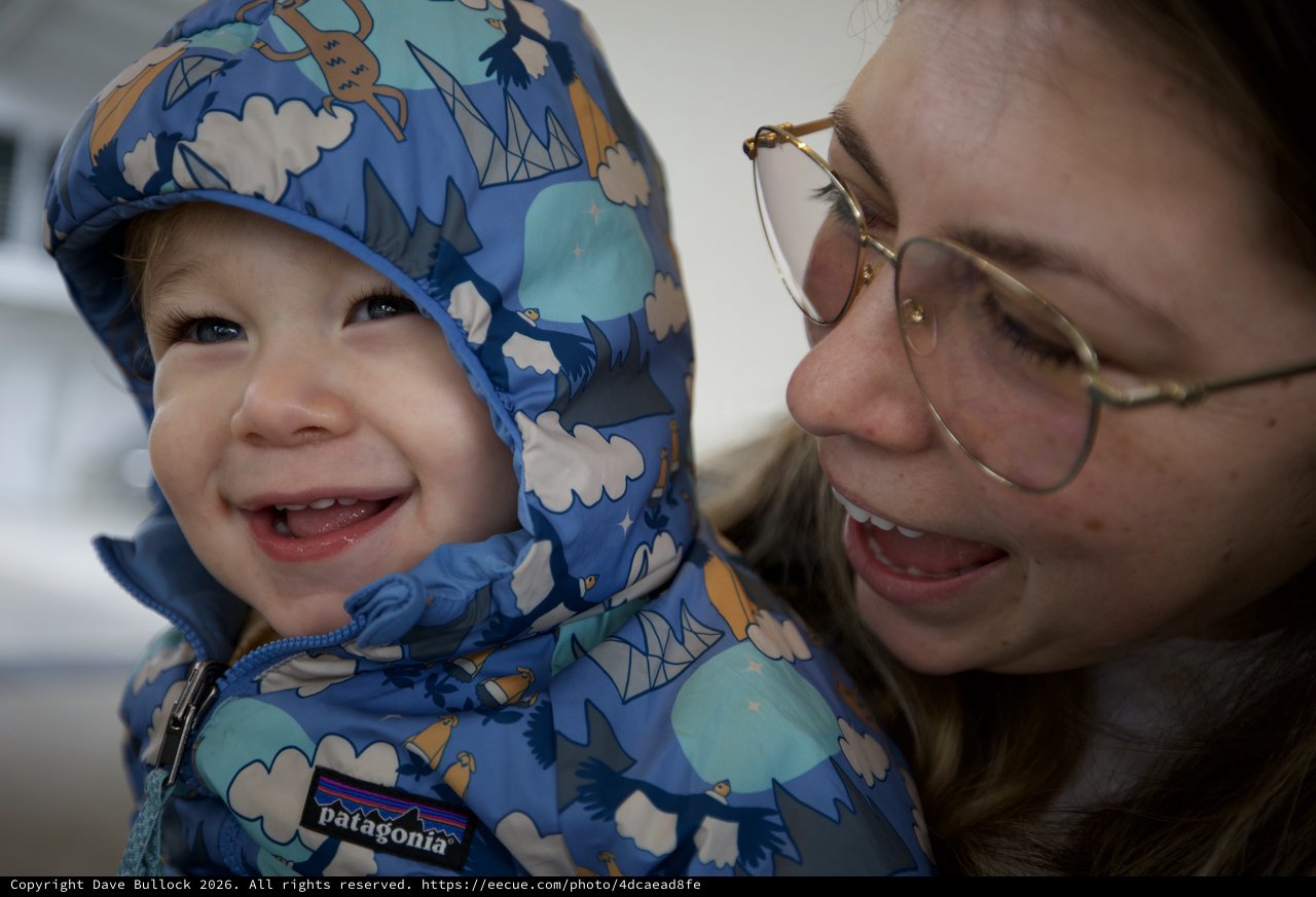 Joyful Winter Moment: Parent and Child Smiling Together