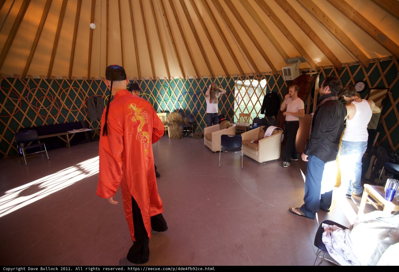Man in Red Robe Standing in Yurt