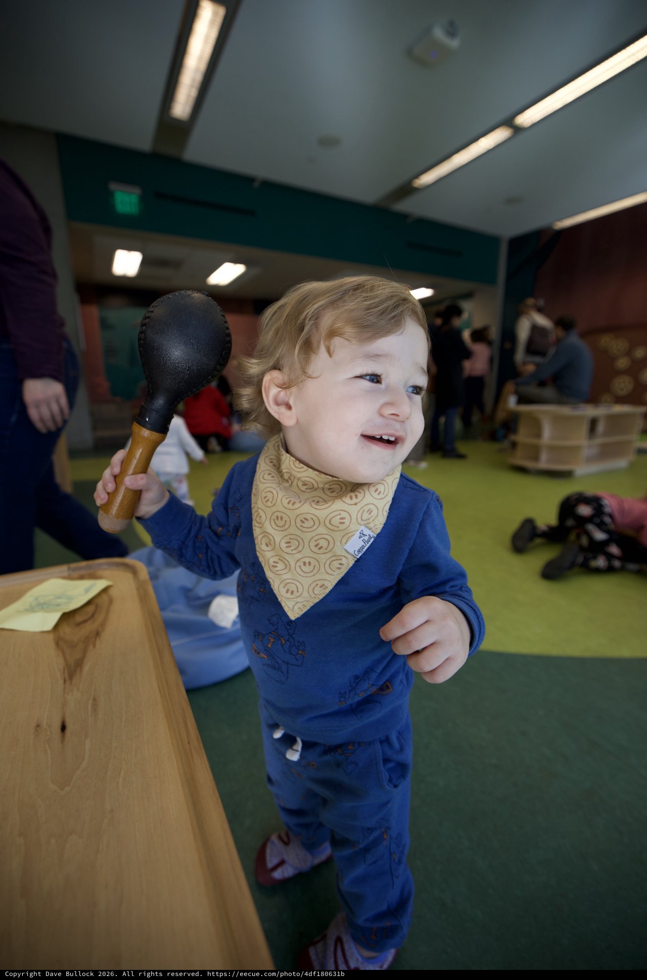 Joyful Toddler Playing with Toy Mallet Indoors