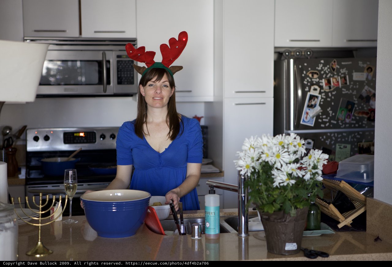 Holiday Hostess with Reindeer Antlers in Kitchen