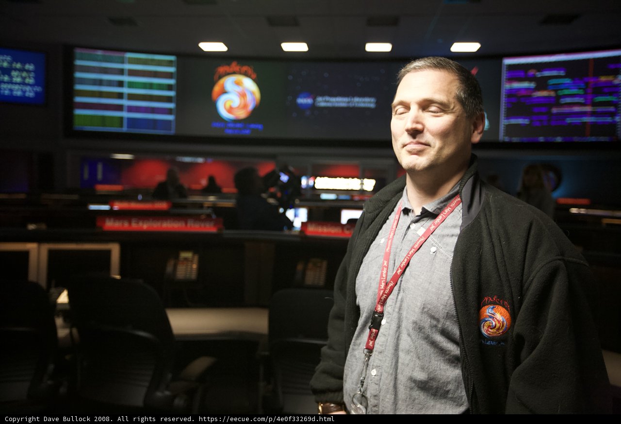 Man Standing in Front of Large Screen