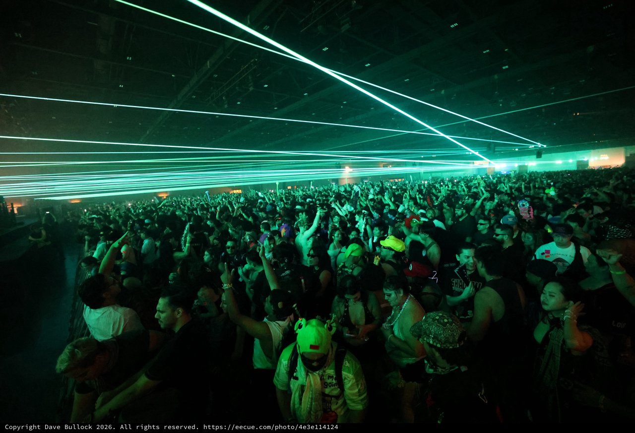 Green Laser Light Show Over Dancing Festival Crowd