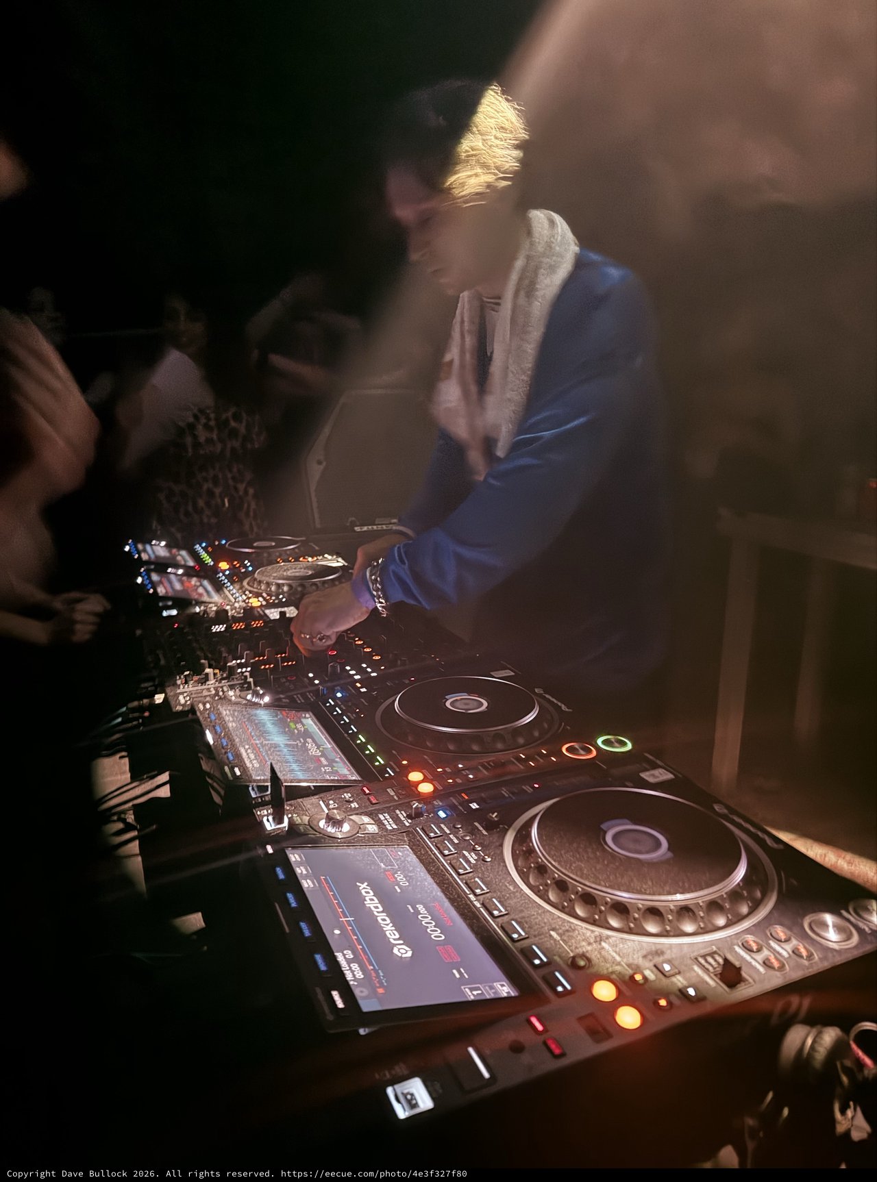 DJ Performing with Professional CDJ Setup at Night