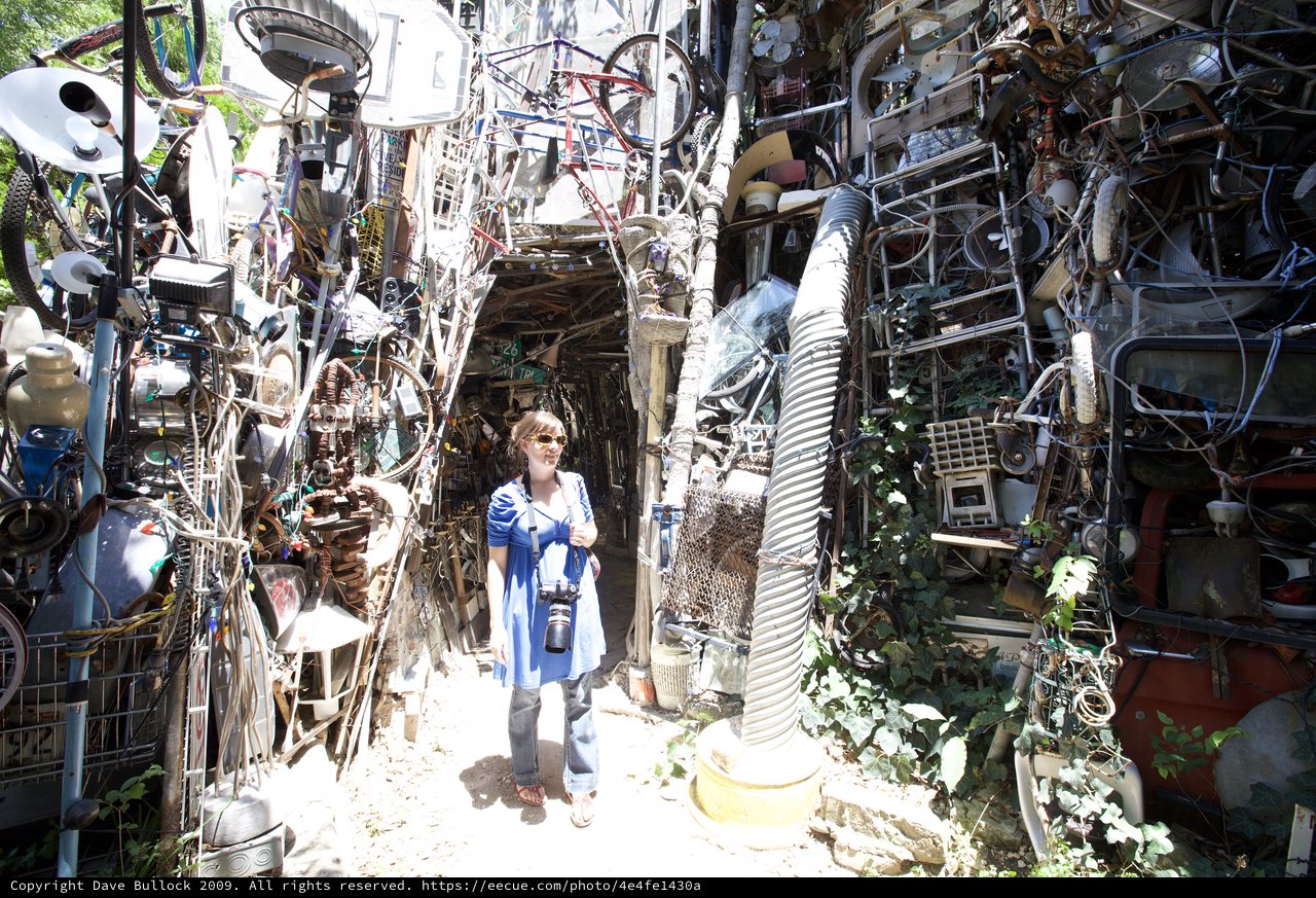 Woman Explorer Amid Cathedral of Junk Austin
