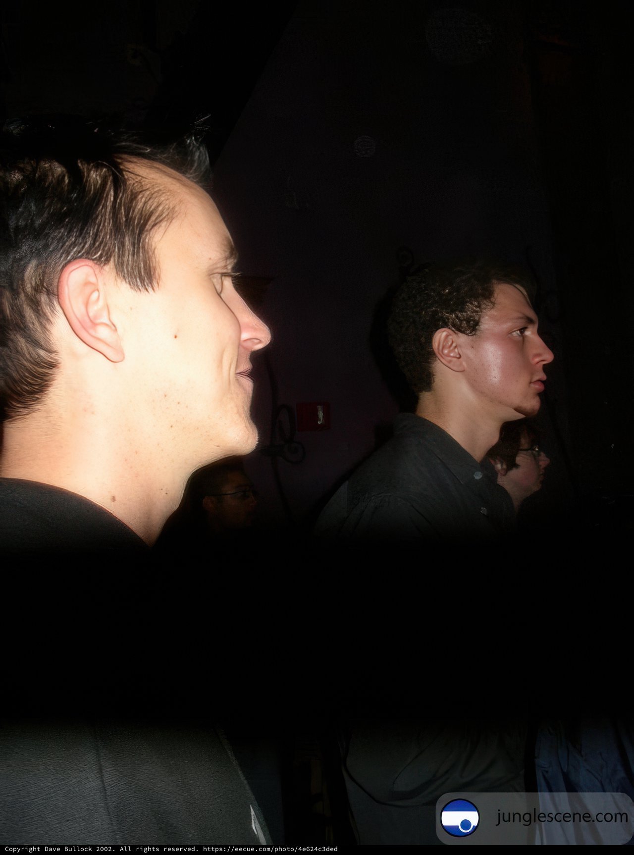 Two men in a dark club room