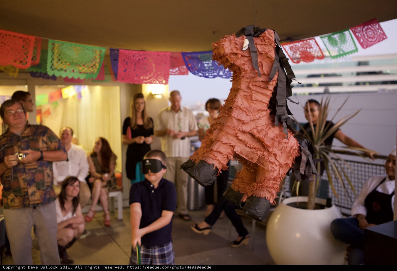 Blindfolded Boy Swings at Piñata at Fiesta