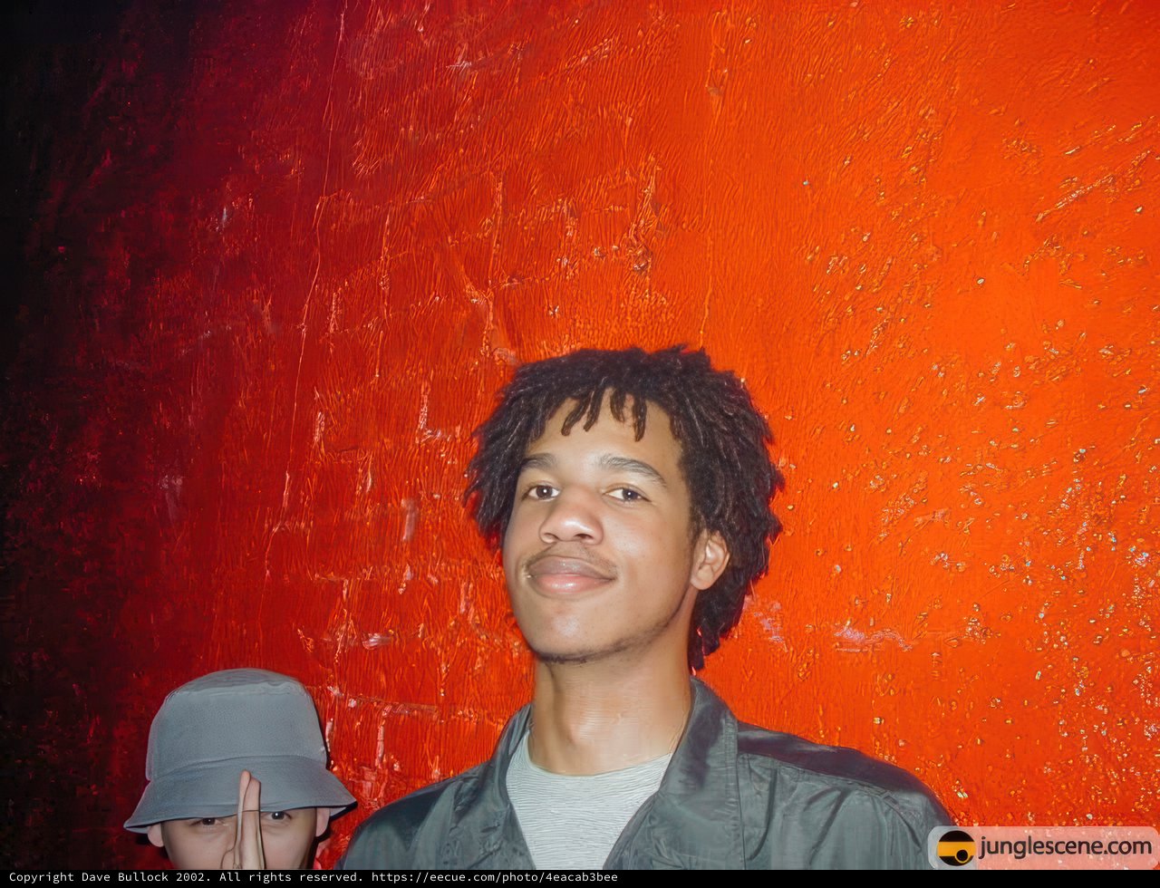 Ron posing next to a brick wall
