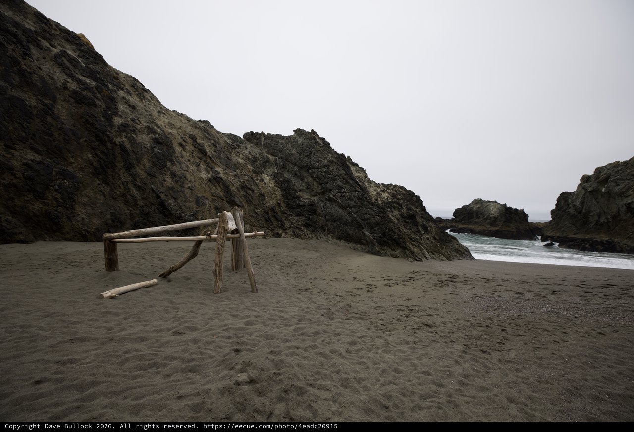 Driftwood Sculpture on Moody Coastal Cove Beach