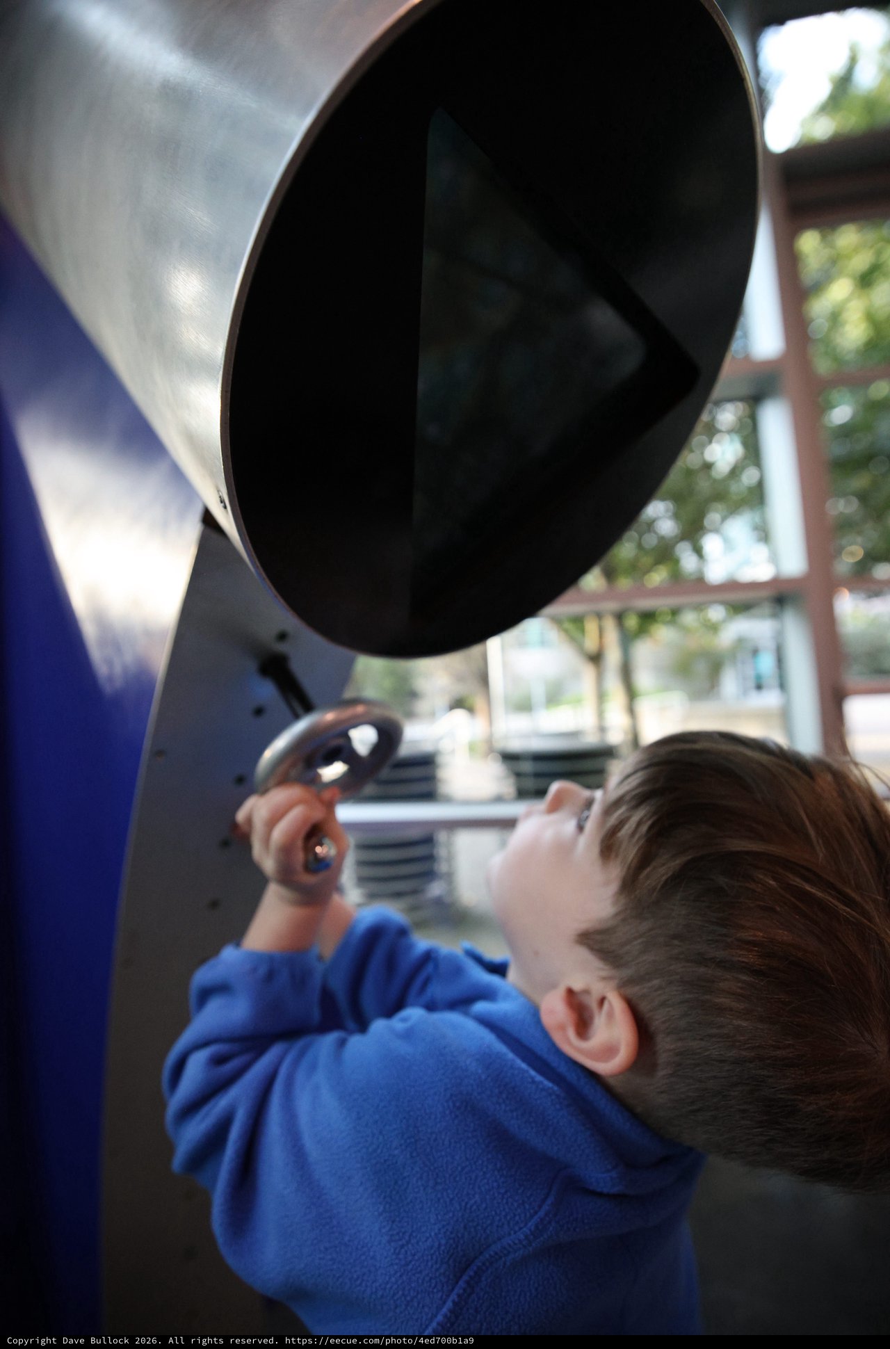 Child Exploring Interactive Exhibit at Science Center