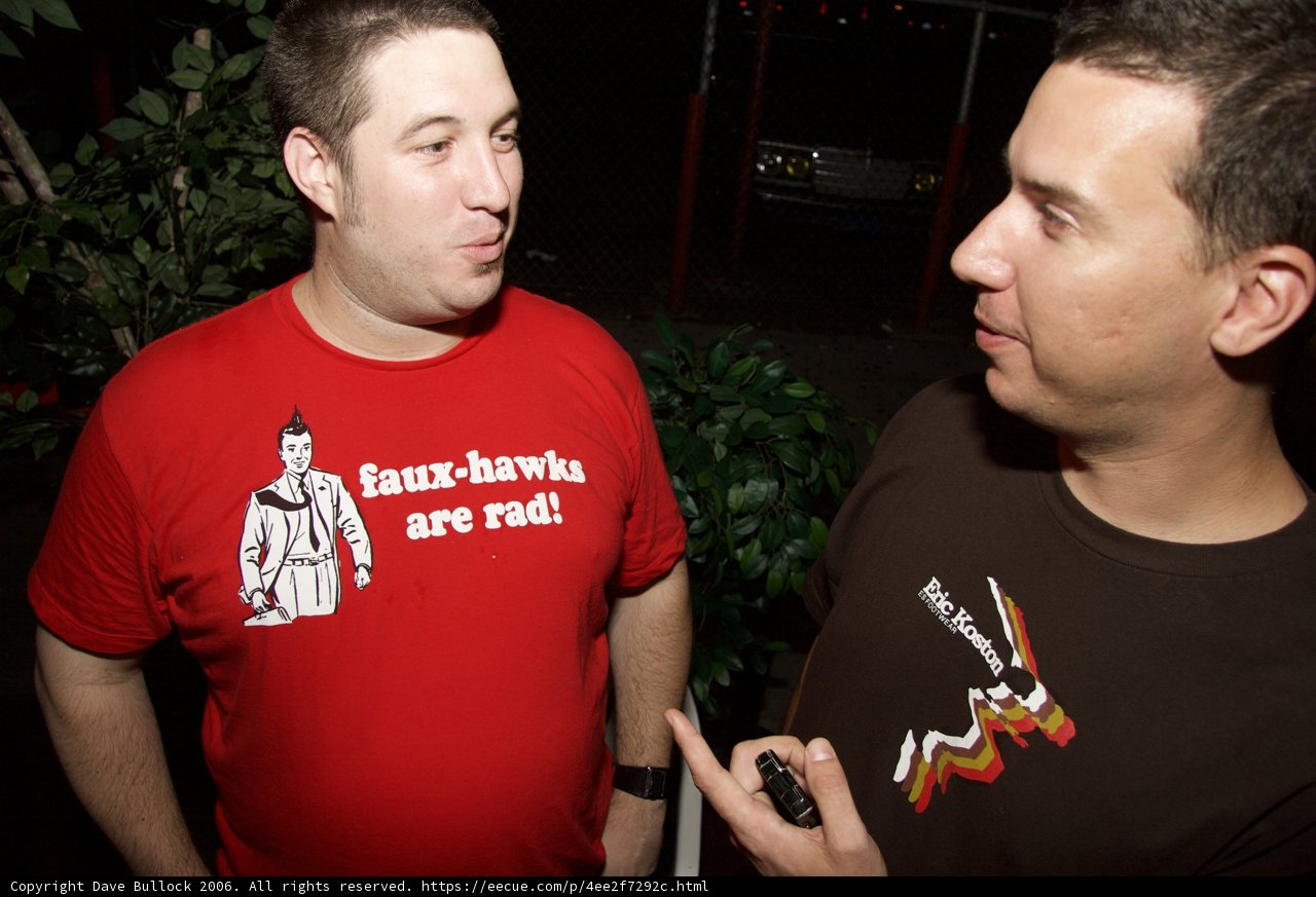 Red Shirted Men Chatting Amidst Foliage
