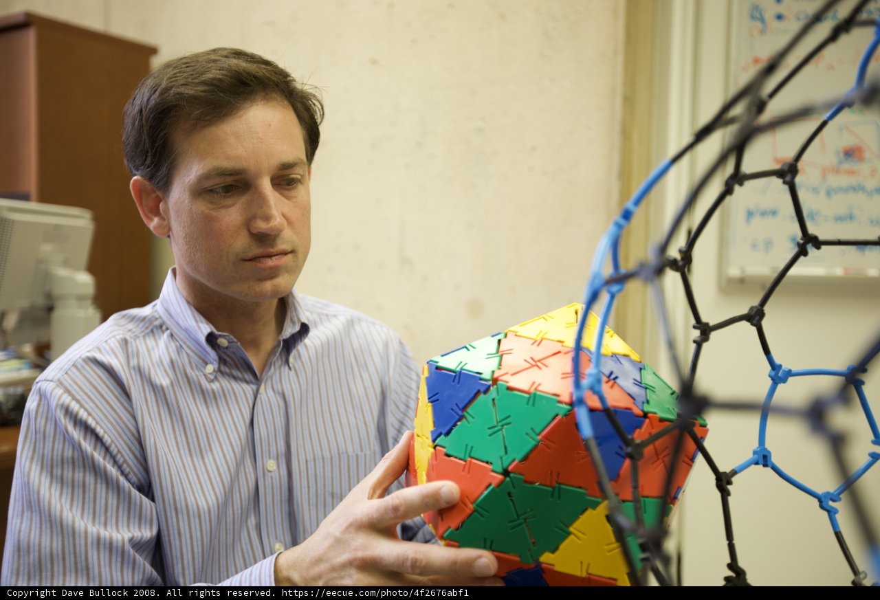 Multi-Colored Sphere in the Hands of a Man