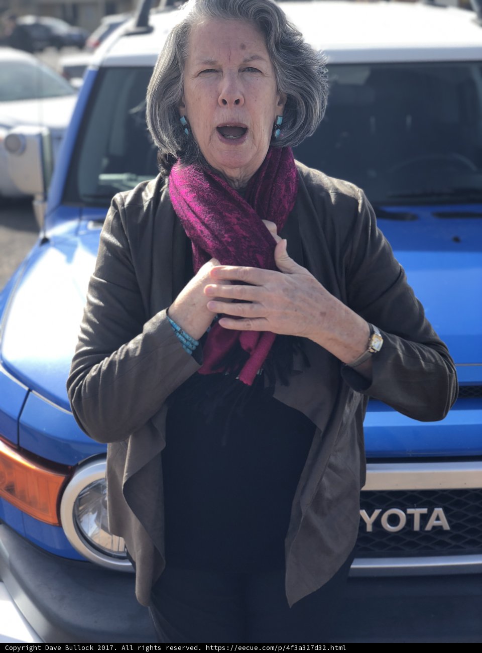 Woman poses with her blue Toyota