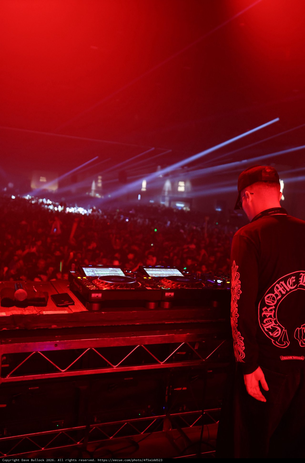 DJ Commands Massive Crowd Under Red Festival Lights