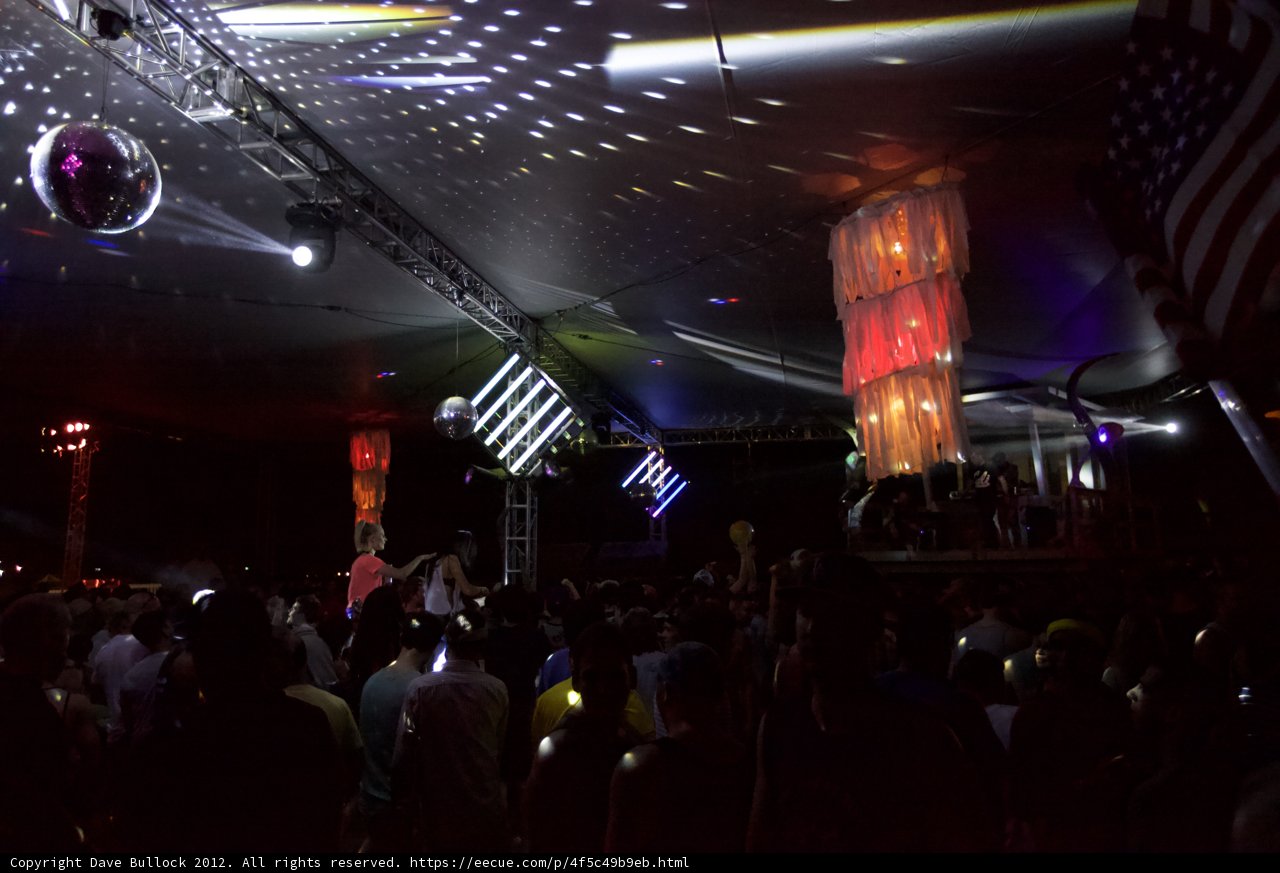 Electric Nightlife: A Crowd Dances Beneath a Swarm of Disco Balls
