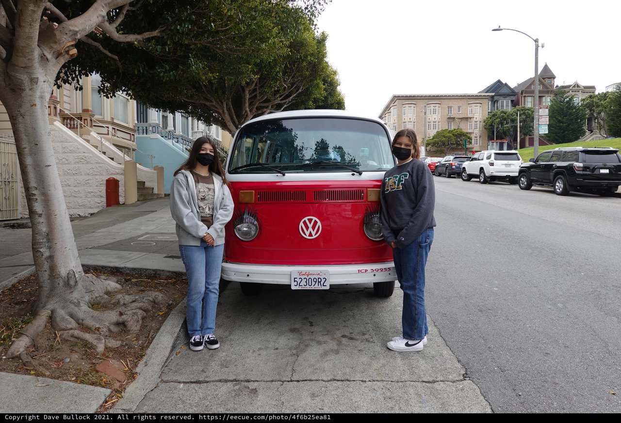 Friends Posing with Classic Red Volkswagen Van
