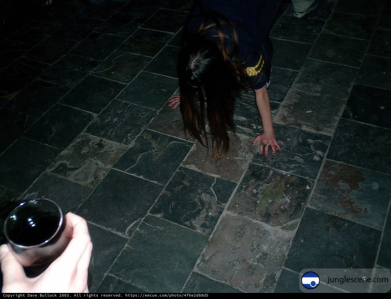 Picking up a bottle on a flagstone path