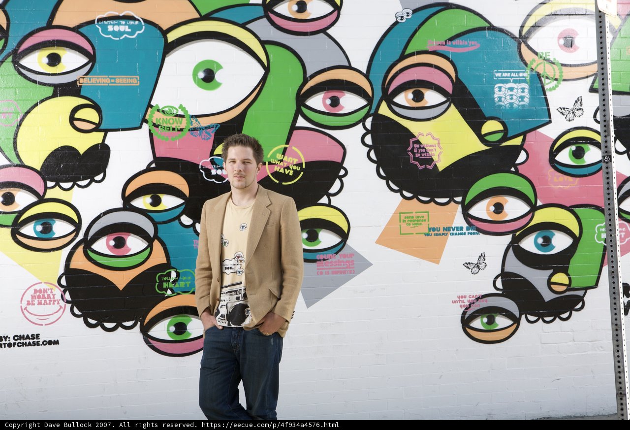 Staring Back: A Man Confronts a Wall of Eyes